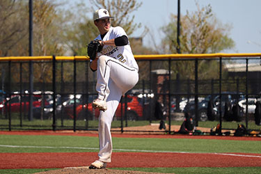 A PNW baseball player prepares to throw a pitch.