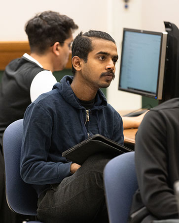 A PNW student listens in a classroom