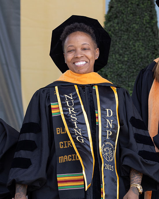 PNW graduates sit together outdoors at Commencement