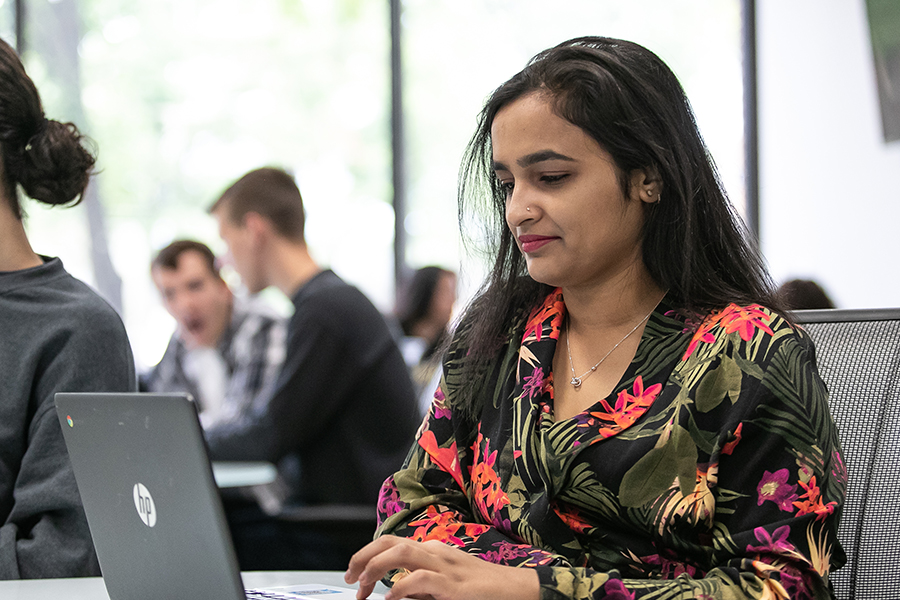 A student in PNW's department of history, philosophy, political science and economics at a computer.