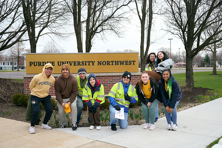 Honors College students pose in front of a Purdue University Northwest sign