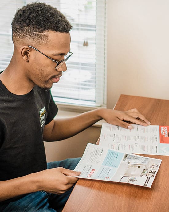 A student reads PNW housing paperwork.