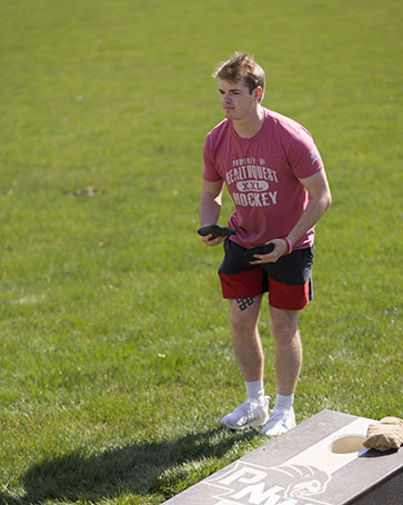 Student plays cornhole outside