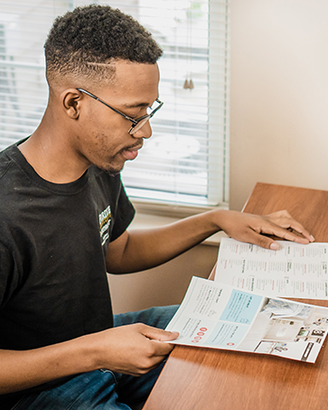 student looking over campus ready materials for housing