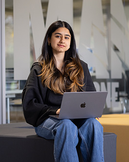 Student on her laptop in the Mane Zone