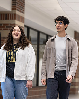 Two students walking in CLO