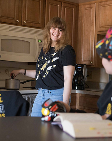Student in Housing talking with another student in the kitchen
