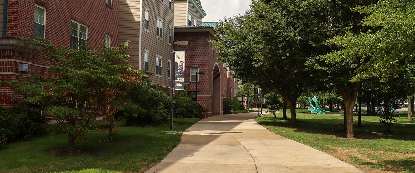 The sidewalk leading up to a PNW residence hall.