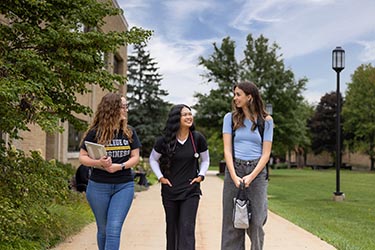 Three PNW students walking on the Westville campus.