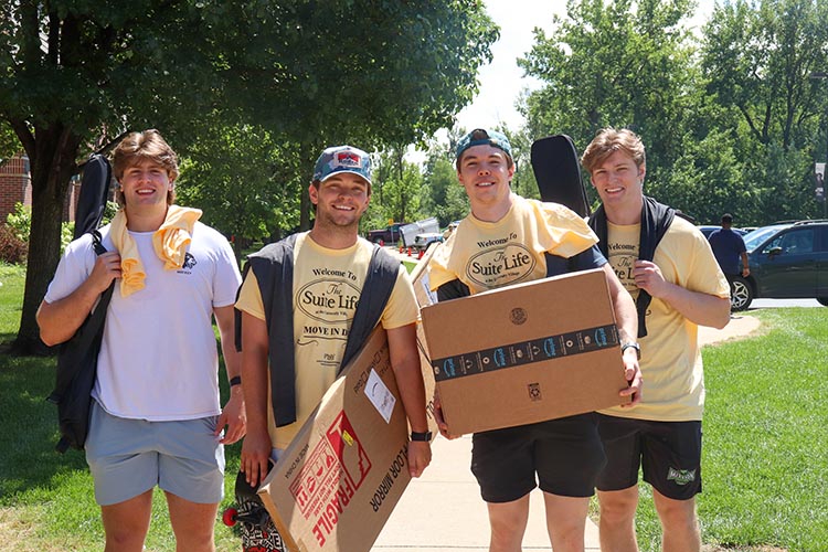 Four PNW students moving into a dorm room