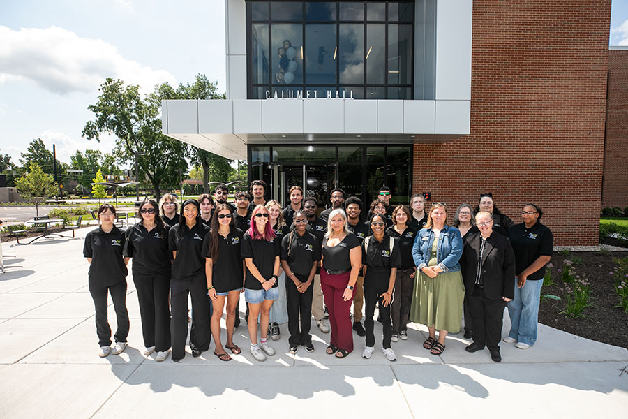 PNW housing staff pose in front of the new Calumet Hall.