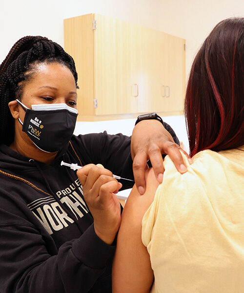 A PNW student is vaccinated for COVID-19 at an on-campus clinic.