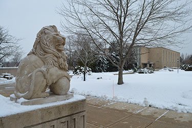 A PNW lion statue covered in snow.