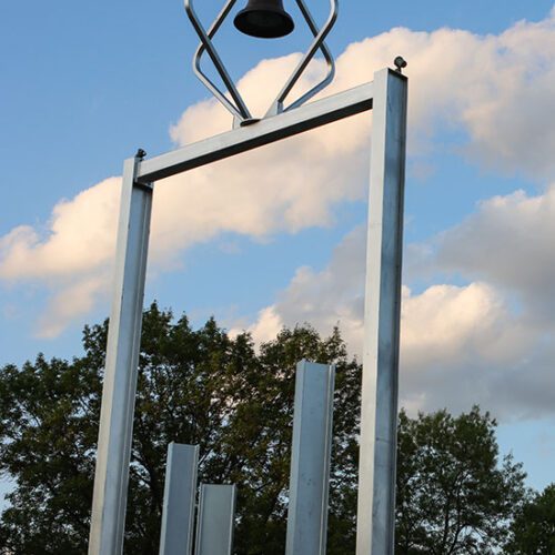 The PNW Bell tower pictured with clouds in the background.