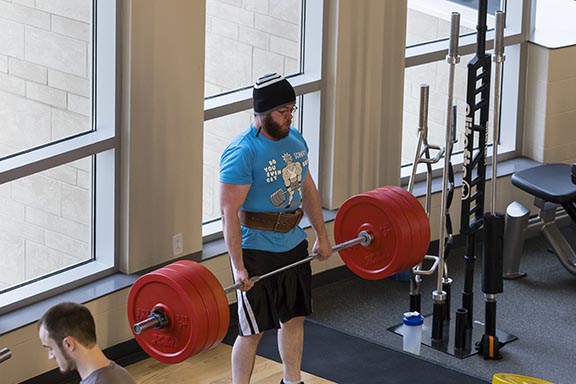 PNW student lifting weights in the gym