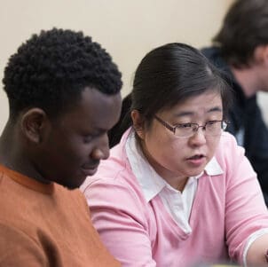 Colleagues collaborate at a computer