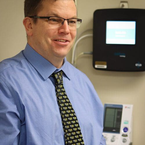 John Durocher stands in a lab