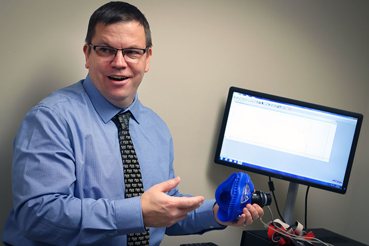 John Durocher displays a sleep apnea mask.