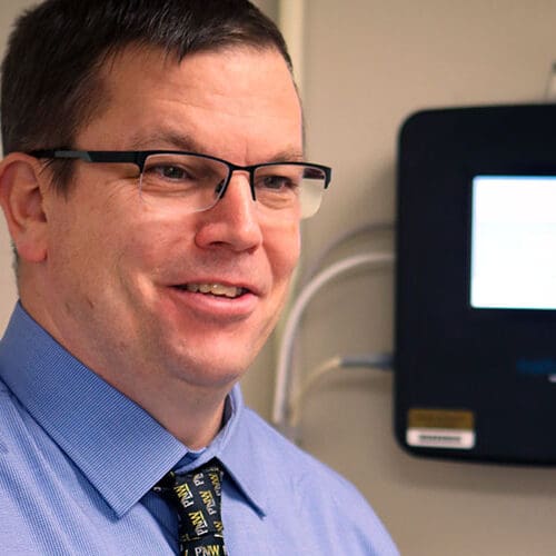 John Durocher stands in a lab