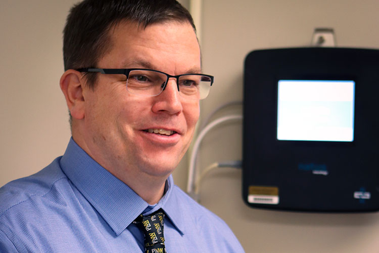 John Durocher stands in a lab