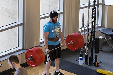 PNW student lifting weights in the gym