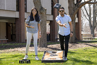 Students play beanbag toss