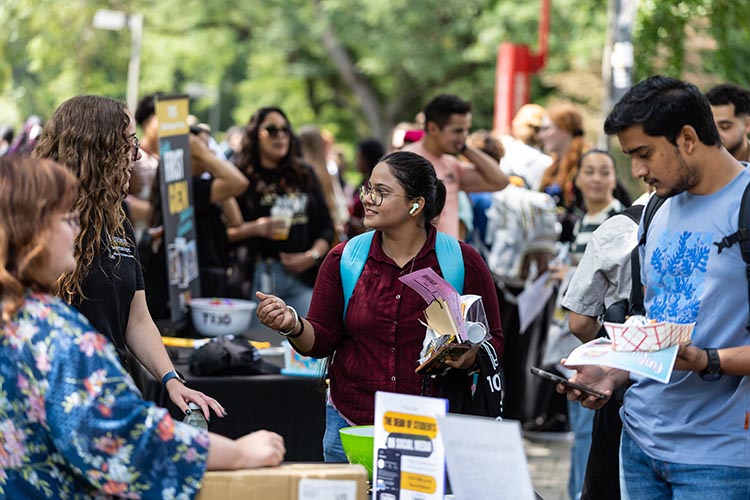 PNW students walking around and talking to different tables at the Fall Welcome Rally.