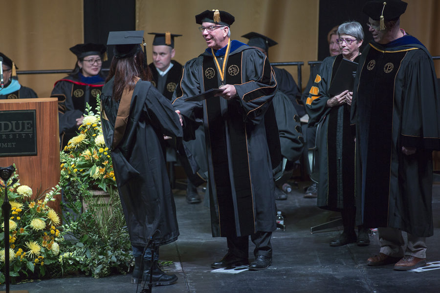 Chancellor Thomas L. Keon shaking hands with a graduating student