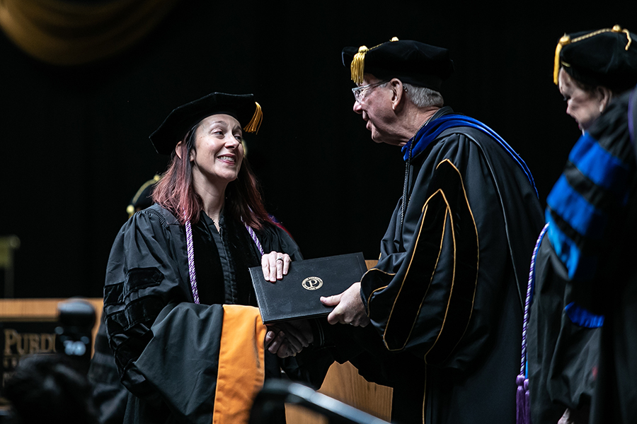 Chancellor congratulating a graduate at Commencement
