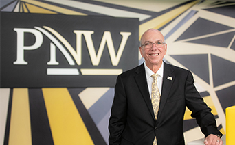 Chancellor Thomas L. Keon in front of a PNW sign
