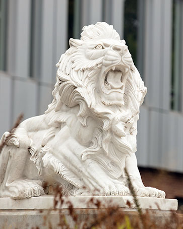 A lion sculpture next to PNW's Nils K. Nelson Bioscience Innovation Building.