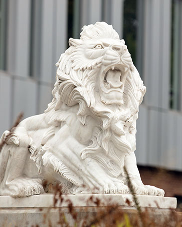 A lion sculpture next to PNW's Nils K. Nelson Bioscience Innovation Building.