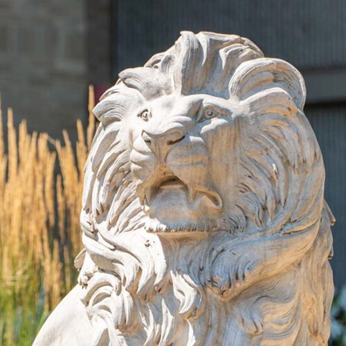 A lion sculpture in front of vegetation on PNW's Westville Campus.
