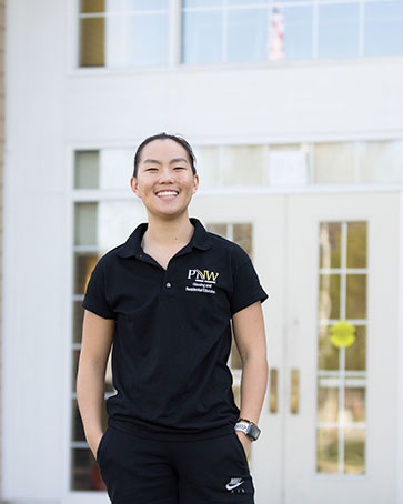 A Purdue Northwest Student stands outdoors