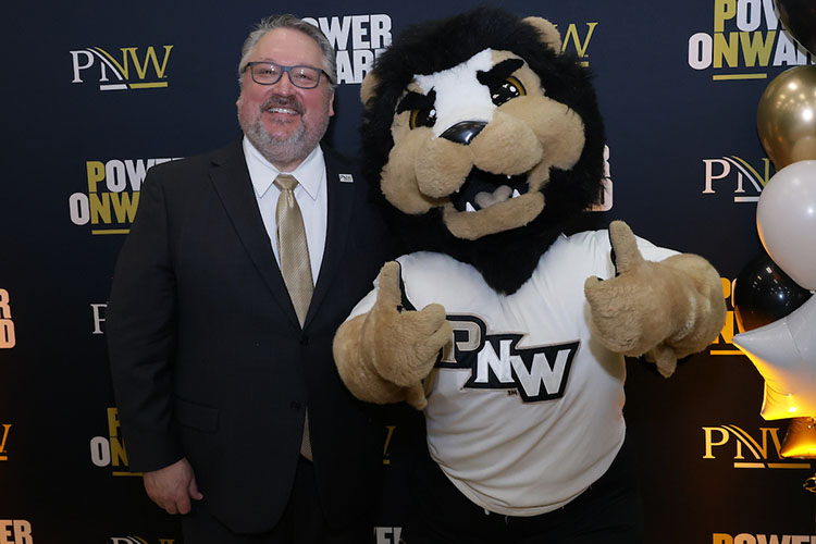 PNW Pride mascot Leo loves any avid Pride Athletics fan, including Chancellor Chris Holford.