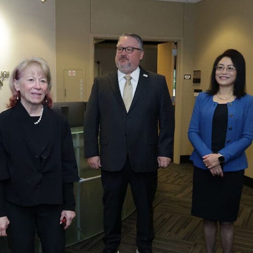 Geri Richmond, Chenn Zhou and Chris Holford stand in the CIVS lobby