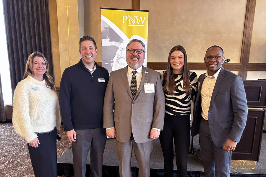 PNW Chancellor Chris Holford poses with PNW alumni at a community event.