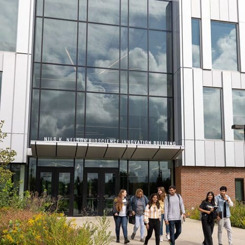 Students walk in front of the Nils K, Nelson Bioscience Innovation Building