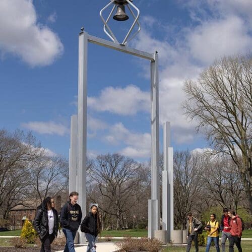 Students walk by the Bell Tower on Purdue University Northwest's Hammond campus