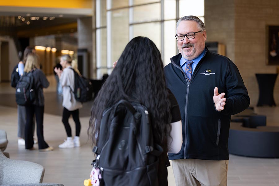 PNW Chancellor Chris Holford talks with a student on PNW's Westville campus
