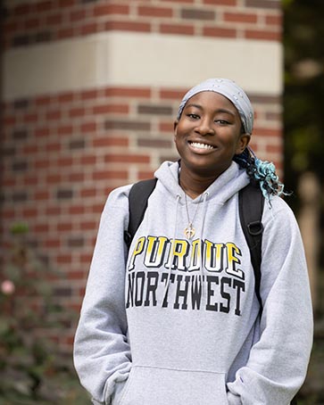 A student poses in a Purdue Northwest sweatshirt.