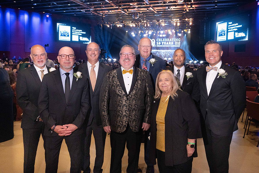 PNW Alumni Hall of Fame inductees pose with PNW Chancellor Kenneth C. Holford (center) at the 10th Anniversary Gala. From left, Alfredo Sori (BS’89); Mitchell “Mason” Macenski (BA’86); Deno Yiankes (BS’88); Stewart McMillan (BS’77); The Honorable Diane Kavadias Schneider (BS’71; MA’23); Robert Johnson III (AAS’89; BS’91; MS’96); and Jeff Strack (MBA’00).