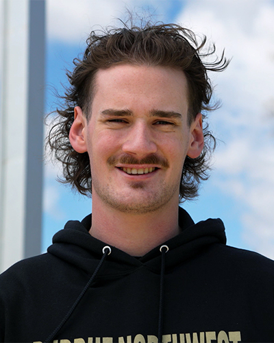 Close up of a PNW student in front of the Bell Tower