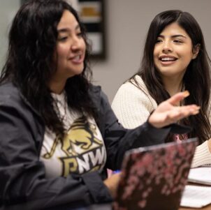 PNW students collaborate over a laptop