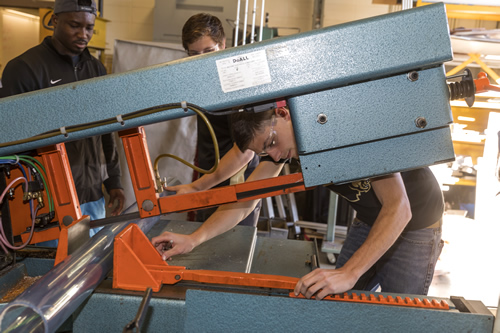 Students working with packaging equipment