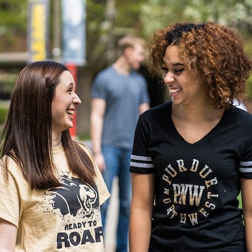 Two students walking are pictured.