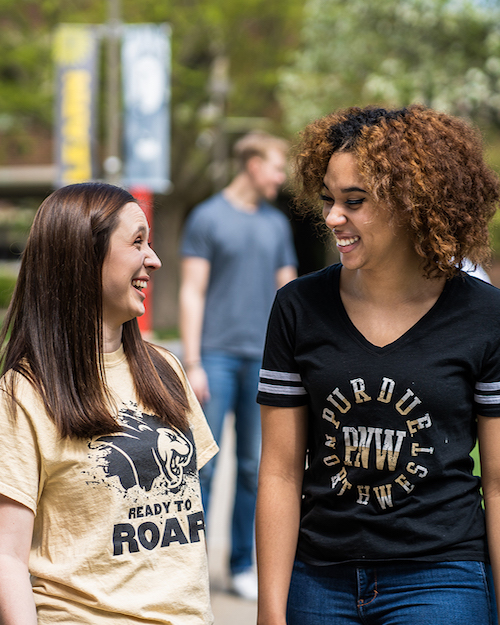 Two students walking are pictured.