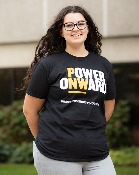 Student poses in a "Power Onward" t-shirt