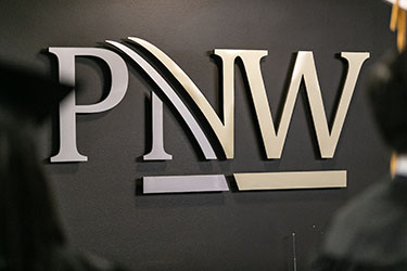 The PNW logo on a sign at Commencement