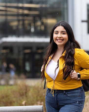 A PNW student posts in front of the Nils K. Nelson Bioscience Innovation Building